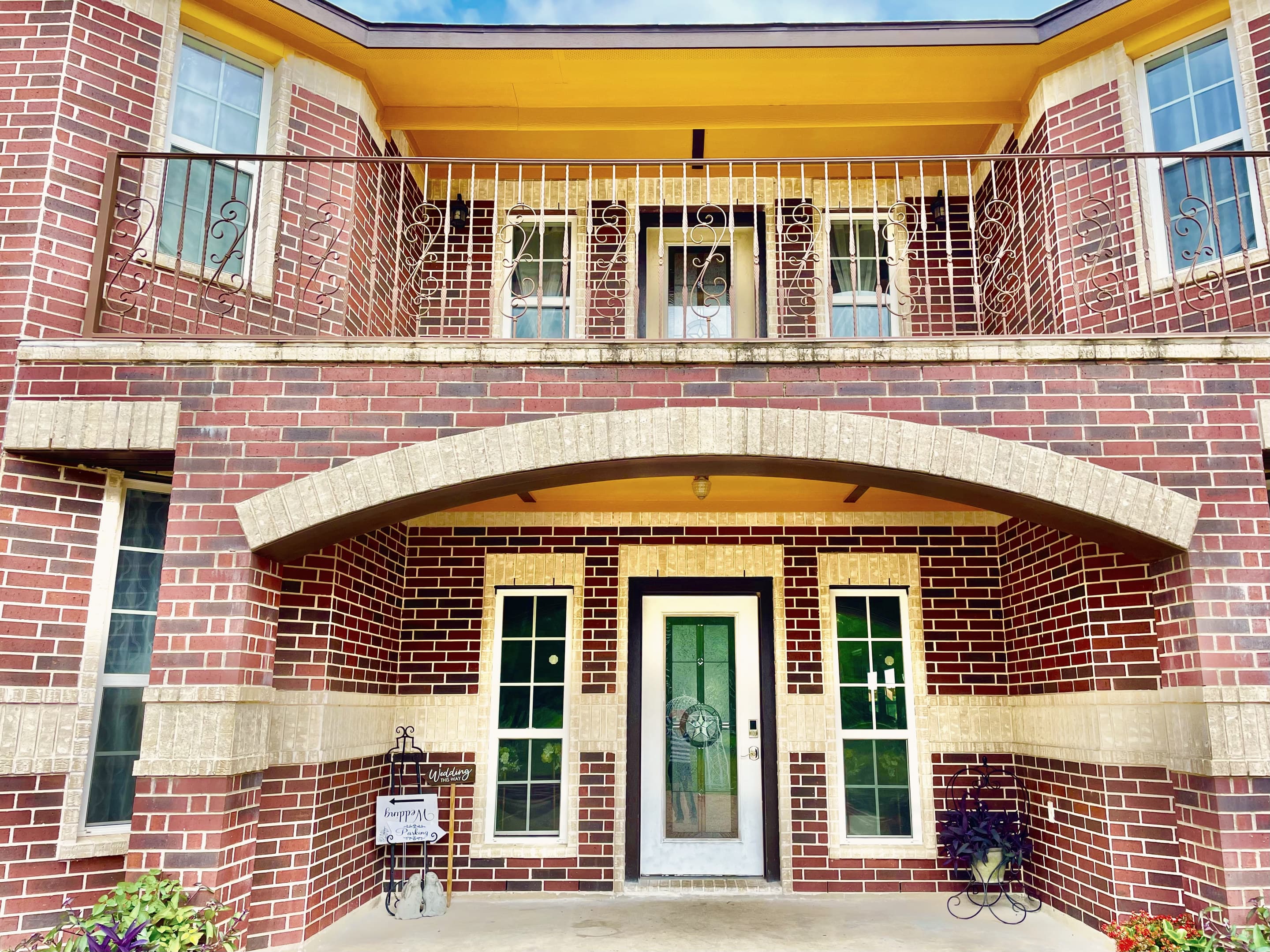 The manor's front entrance beneath an arched balcony