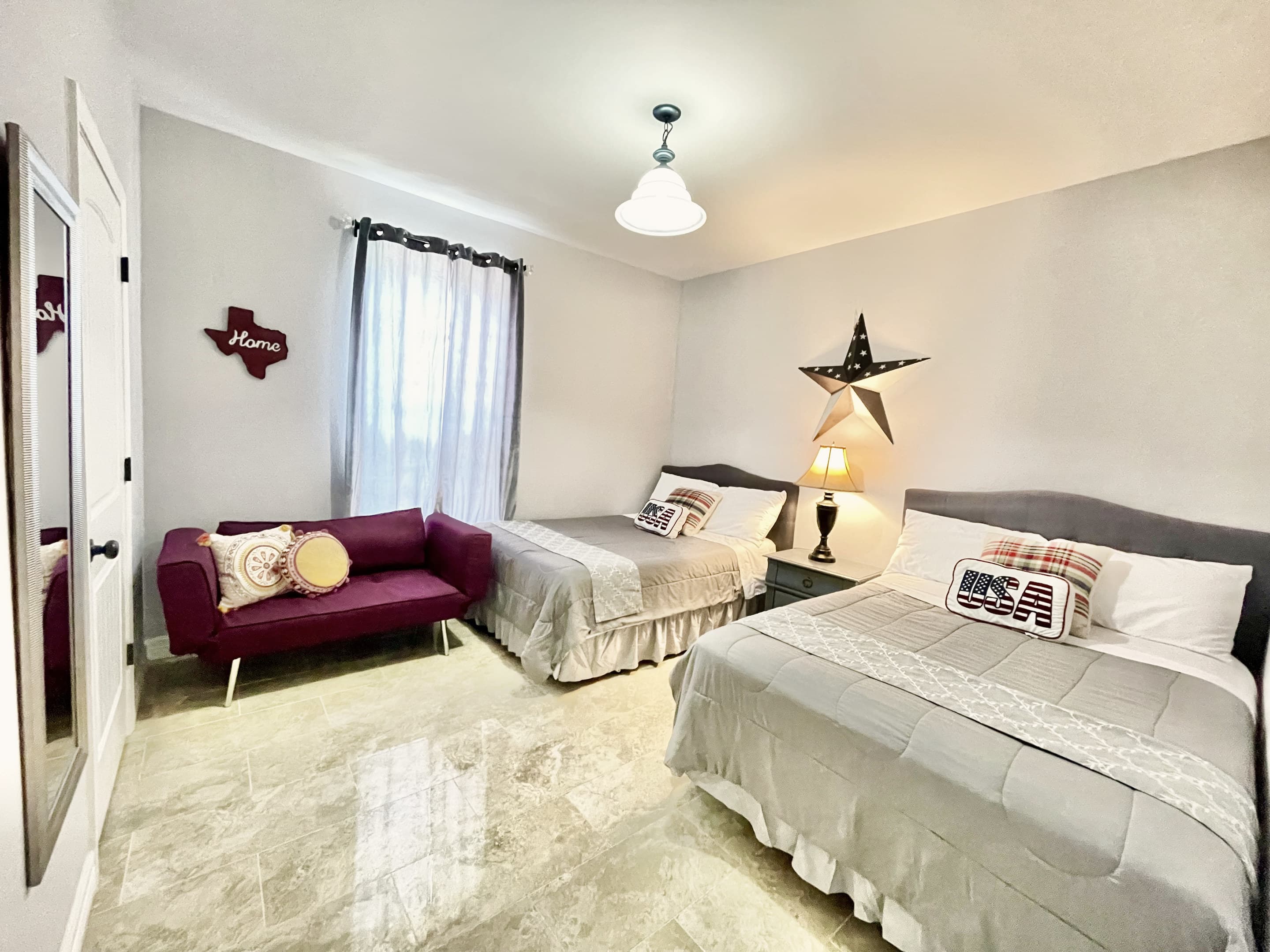 A guest bedroom with a bed and a daybed, Texas-star decor on the wall