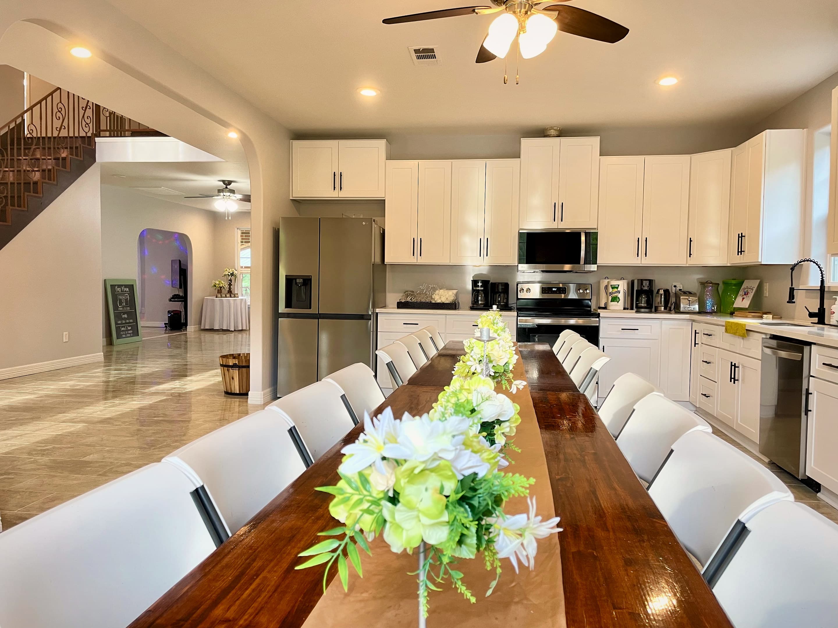 The kitchen and long dining table dressed with white florals
