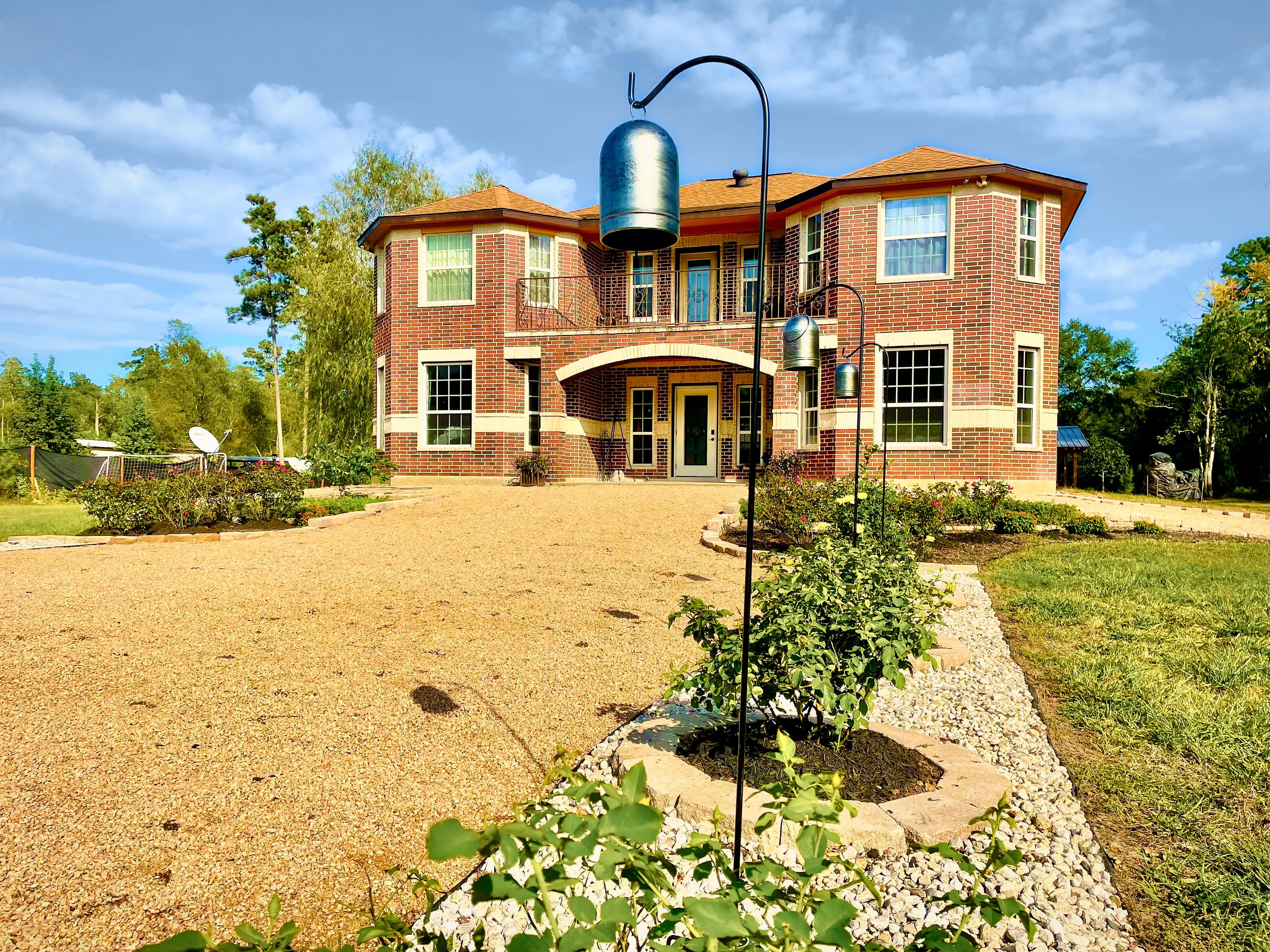 The manor's front approach along a gravel drive bordered by young plantings