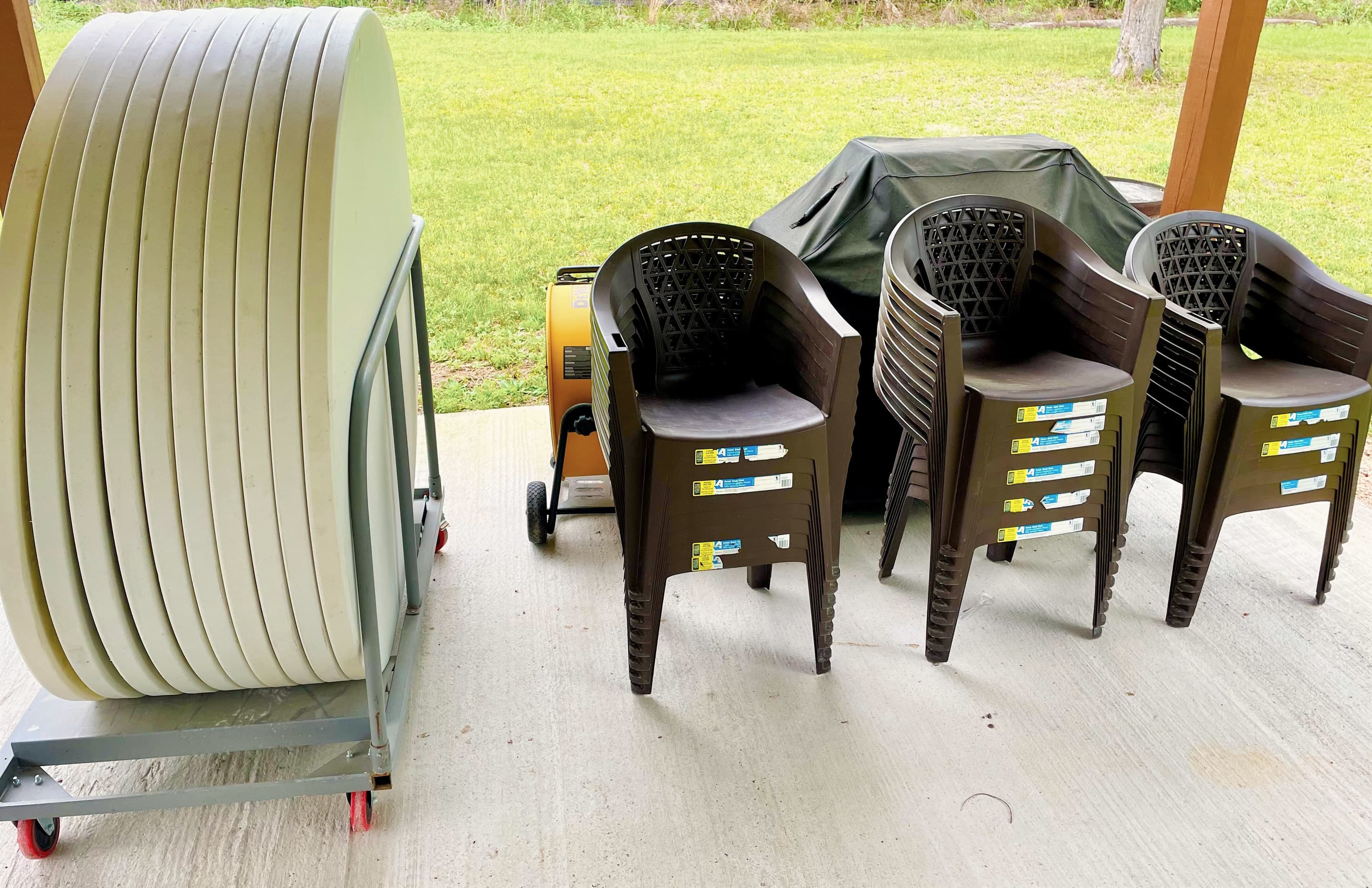 Round party tables and stacked chairs ready for an event