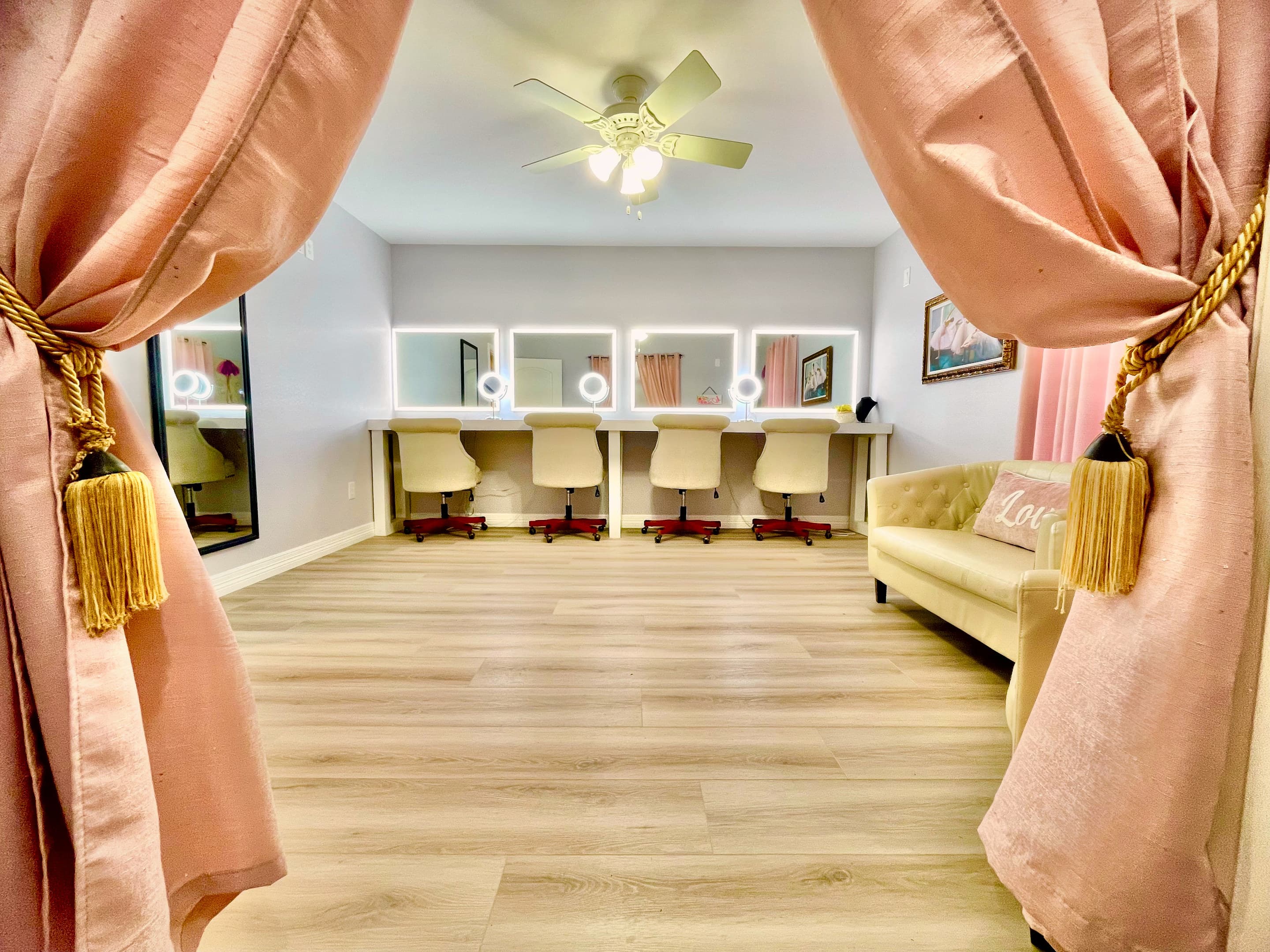 Blush velvet drapes tied back to reveal the bridal suite's vanity stations
